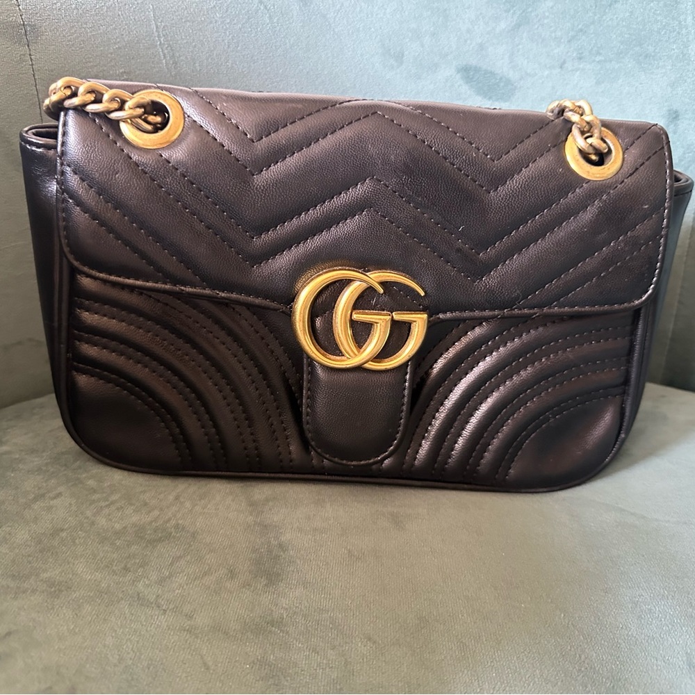 Gucci replica.  Black with gold chain